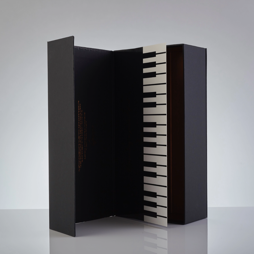 Standing view of the handmade Gary Barlow piano box, featuring an embossed piano key design, perfect for gifting wines in a stylish and unique presentation.