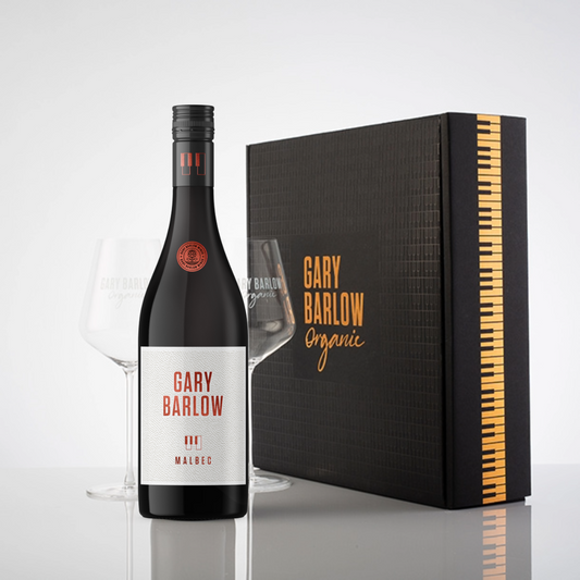 Gary Barlow Wow Box featuring his hallmark piano key and copper-embossed design, showcasing 1 bottle of Gary Barlow Malbec and 2 wine glasses.